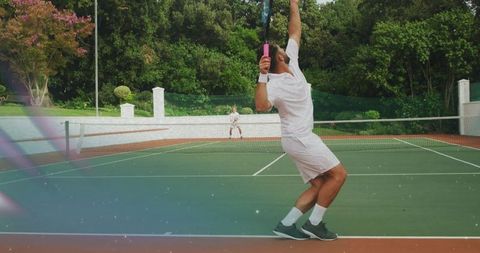 Tennis Player Executing Powerful Serve on Outdoor Court