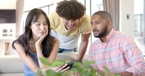 Diverse Friends Socializing at Home with Smartphone Engagement