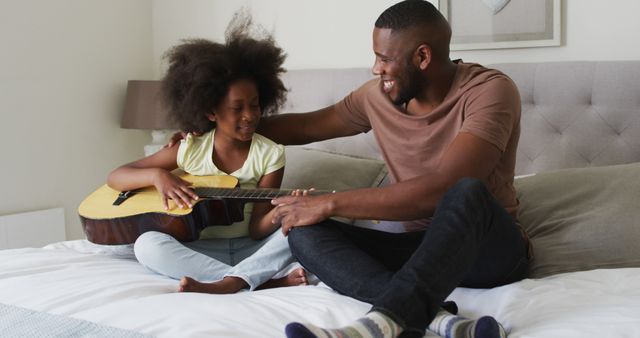 Father and Daughter Bonding Over Guitar Lesson on Bed - Download Free Stock Images Pikwizard.com