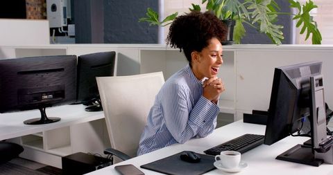 Businesswoman Enjoying Productive Day at Office Desk with Computer - Download Free Stock Images Pikwizard.com