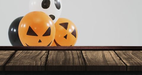 Halloween Balloons with Pumpkin Faces on Rustic Wooden Table - Download Free Stock Images Pikwizard.com
