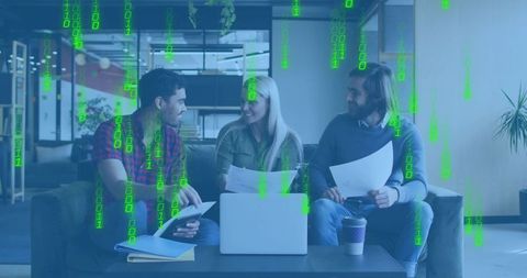 Startup team collaborating over laptop with green binary code overlay in modern lounge