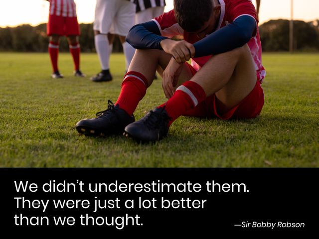 Diverse football players on grass field, some standing, one sitting and looking pensive, reflecting after a game loss. Includes an inspirational quote by Sir Bobby Robson. Useful for illustrating perseverance, team spirit, sportsmanship, and motivational concepts. Ideal for sports articles, motivational blog posts, or social media graphics related to sports and resilience.