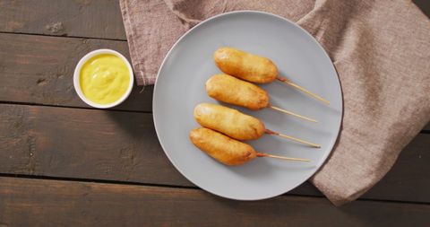corn dogs on plate with mustard dip on rustic table - Download Free Stock Images Pikwizard.com