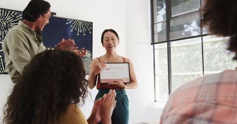 Diverse Team Celebrating Achievement in Bright Office Setting