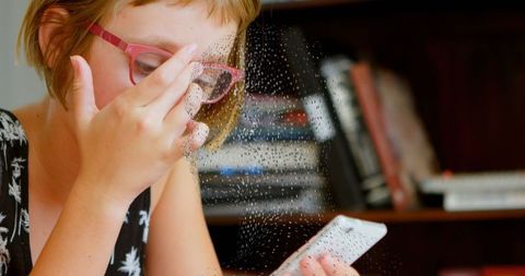 Young Girl Focused on Smartphone with Digital Graphic Overlay