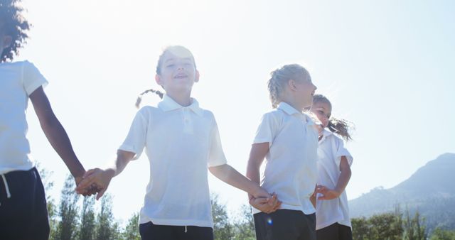 Children Holding Hands Outdoors in Sunlight - Download Free Stock Images Pikwizard.com