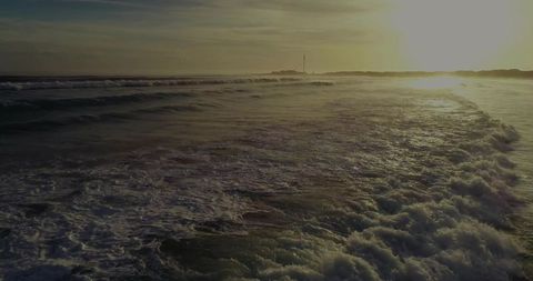 Golden Hour Waves Rolling Amidst Serene Coastal Seascape