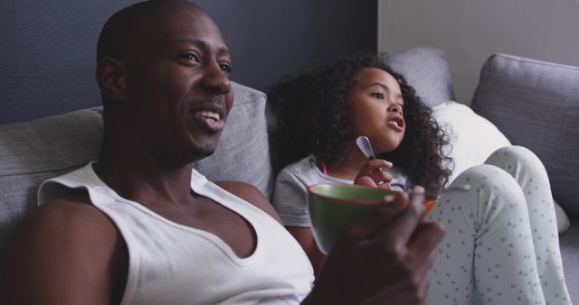 Relaxed African American Father and Daughter Enjoying Breakfast on Couch - Download Free Stock Images Pikwizard.com