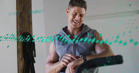 Man checking smartwatch during home workout with teal biometric data overlay