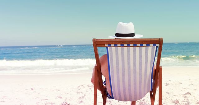 Person Relaxing on Beach Chair Under Hat Facing Ocean - Download Free Stock Images Pikwizard.com