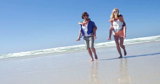 A family enjoys a carefree beach day, symbolizing relaxation and bonding. - Download Free Stock Photos Pikwizard.com