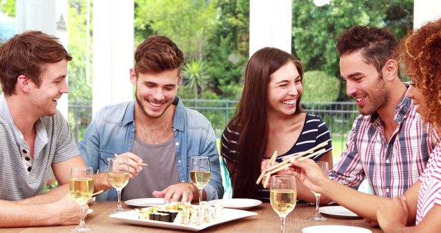 Friends Enjoying Sushi Togetherl at Dining Table - Download Free Stock Images Pikwizard.com