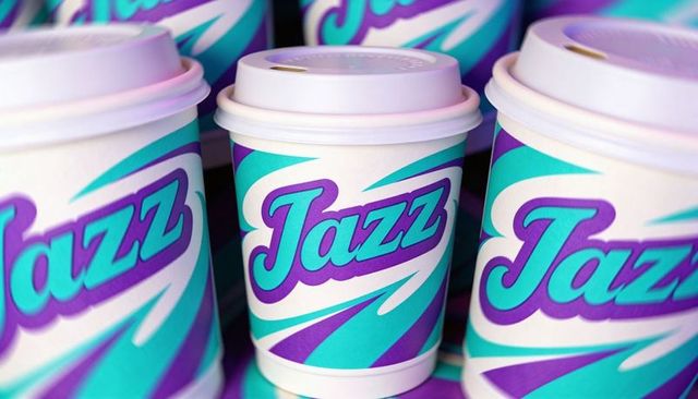 Jazz coffee cup branding teal purple retro swoosh to-go cups close-up macro packaging mockup