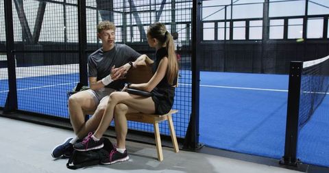 Teammates preparing for padel match showcasing determination