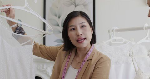 Bridal Preparation at Home Holding Wedding Dress