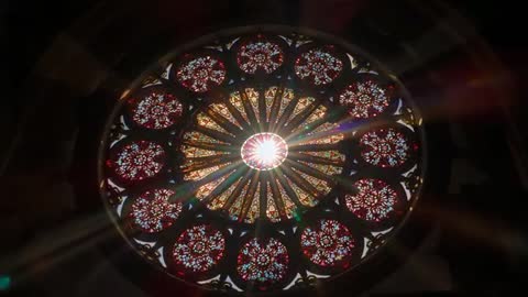 Sunlight Shining Through Stained Glass Rose Window in Cathedral