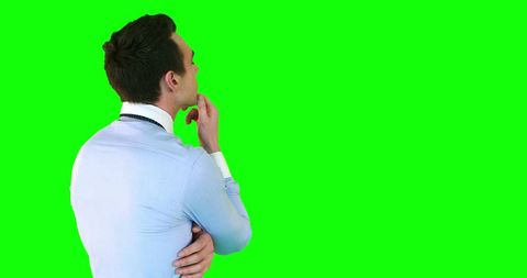Pensive Businessman Contemplating Ideas on Green Background - Download Free Stock Images Pikwizard.com