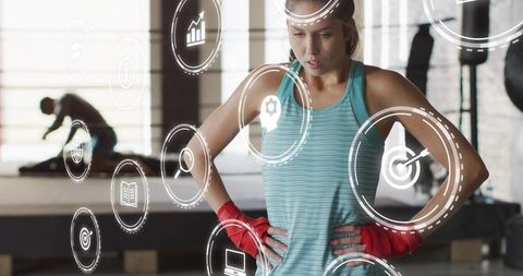 Female boxer catching breath after intense training with futuristic hud fitness overlay