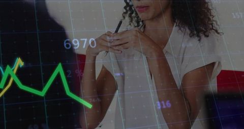 Businesswoman indicative analysis on financial trends with chart overlay