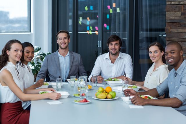 Portrait of smiling business executives having meal in office