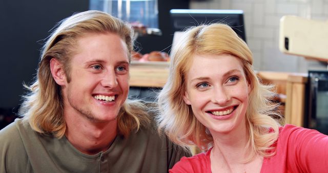 Smiling couple taking a selfie in cafe