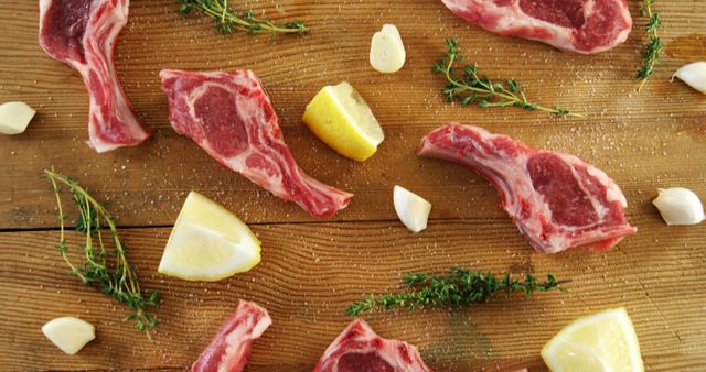 Raw Lamb Chops with Garlic, Lemon, and Herbs on Wooden Surface - Download Free Stock Images Pikwizard.com