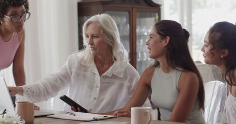 Diverse Women Collaborating on Wedding Plans at Home
