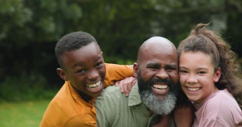 Happy African American Family Outdoors on Grassy Lawn