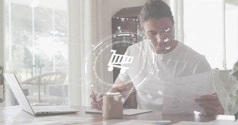 Remote worker reviewing documents and writing notes at home desk with digital shopping hud