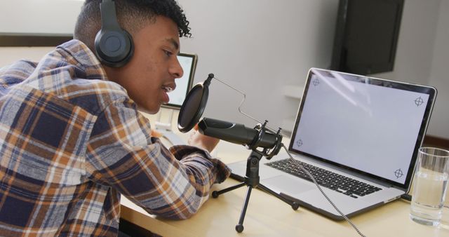 Young Man Podcasting at Home Office with Laptop and Microphone - Download Free Stock Images Pikwizard.com