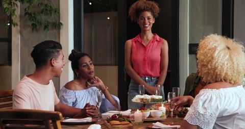 Diverse Friends Celebrating Dinner Party with Joyful Toasting