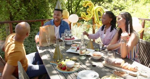 Joyful Birthday Celebration with Friends in Garden Setting