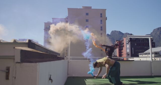 Friends Celebrating with Colorful Smoke on Rooftop - Download Free Stock Images Pikwizard.com