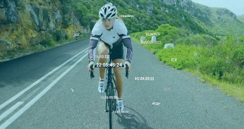 Cyclist Riding Mountain Road with Digital Data Technology