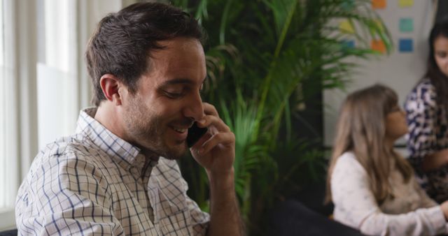 Man on Phone in Modern Office Environment - Download Free Stock Images Pikwizard.com