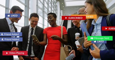 Corporate team gathering around smartphone showing social media notifications in atrium