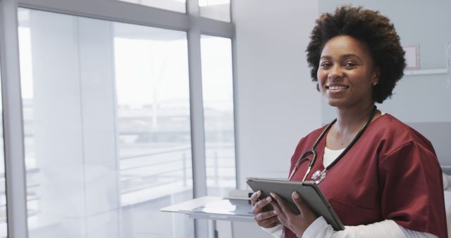 Smiling African American Nurse in Hospital with Tablet - Download Free Stock Images Pikwizard.com