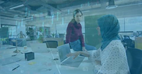 Diverse Coworkers Collaborating in Modern Office with Financial Data Overlay