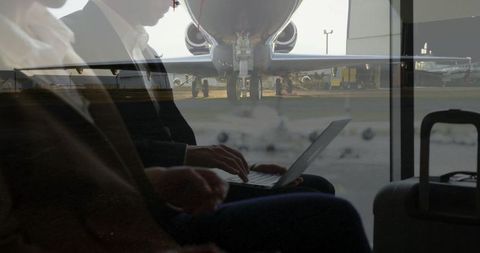 Busy Professionals at Airport Lounge Working During Layover