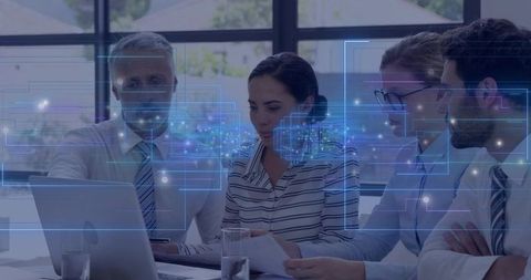 Business team analyzing data visualization on laptop during strategy meeting