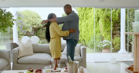 Joyful African American Couple Embracing at Home Celebration