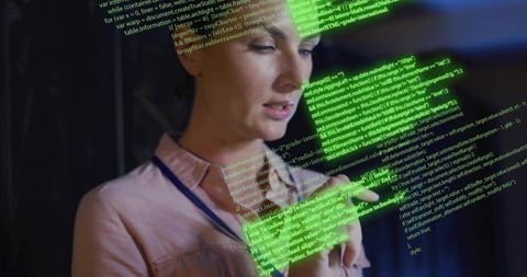 Woman Holding Smartphone Reading Neon Green Code in Dim Office