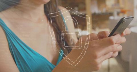 Woman using smartphone with cybersecurity overlay in modern cafe