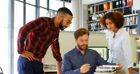 Collaborative team discussing design project in modern office