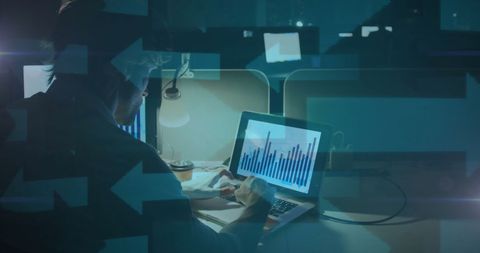 Business Professional Analyzing Data on Laptop Late at Night