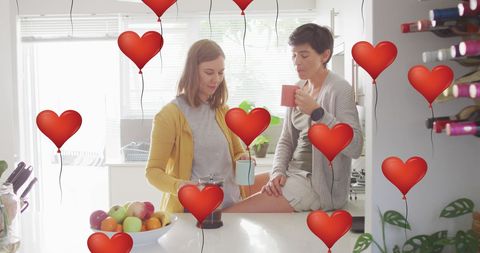 Two Women Enjoying Coffee with Heart Balloons Overlay
