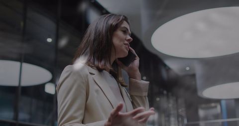 Businesswoman engaging in office phone conversation