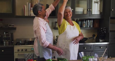 Senior Couple Dancing Joyfully in Kitchen