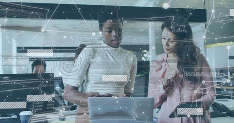 Businesswomen Analyzing Network Data on Digital Devices